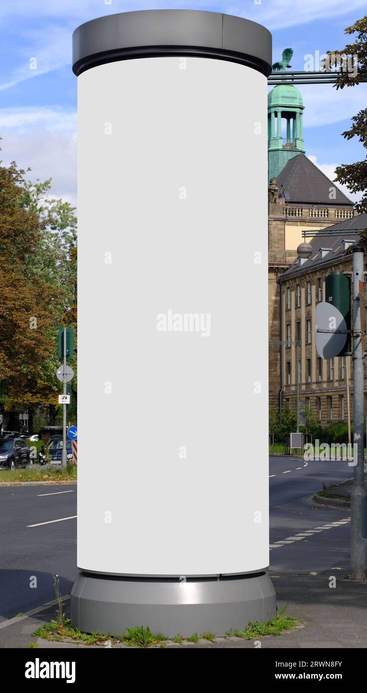 Empty advertising pillar in a city with white  free copy space, promotion mock up. Blank advertising panel Stock Photo