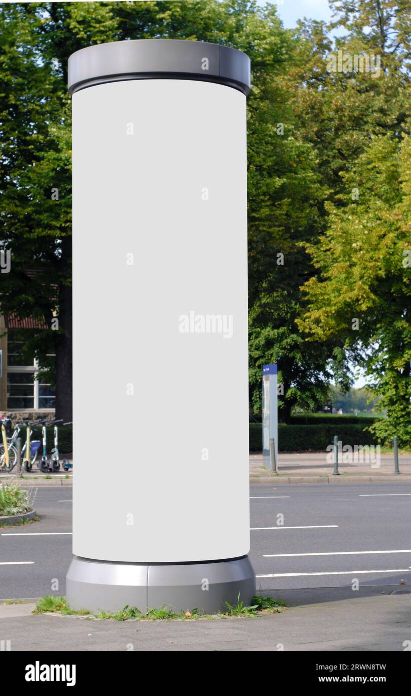 Empty advertising pillar in a city with white  free copy space, promotion mock up. Blank advertising panel Stock Photo