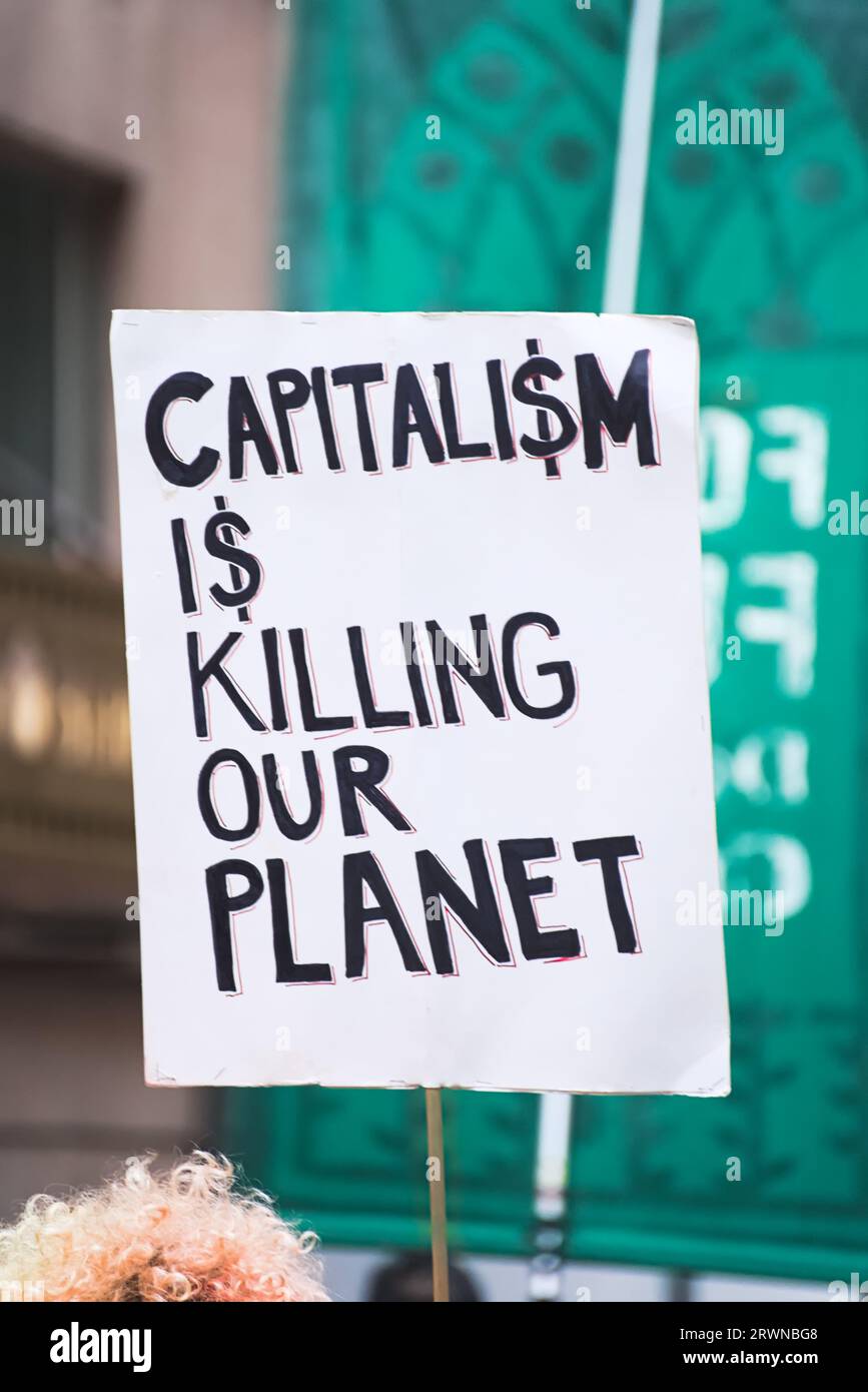 New York, NY - September 17, 2023: Environmental activist's Anti-capitalism slogan in protest of the fossil fuel industry's corporate greed Stock Photo