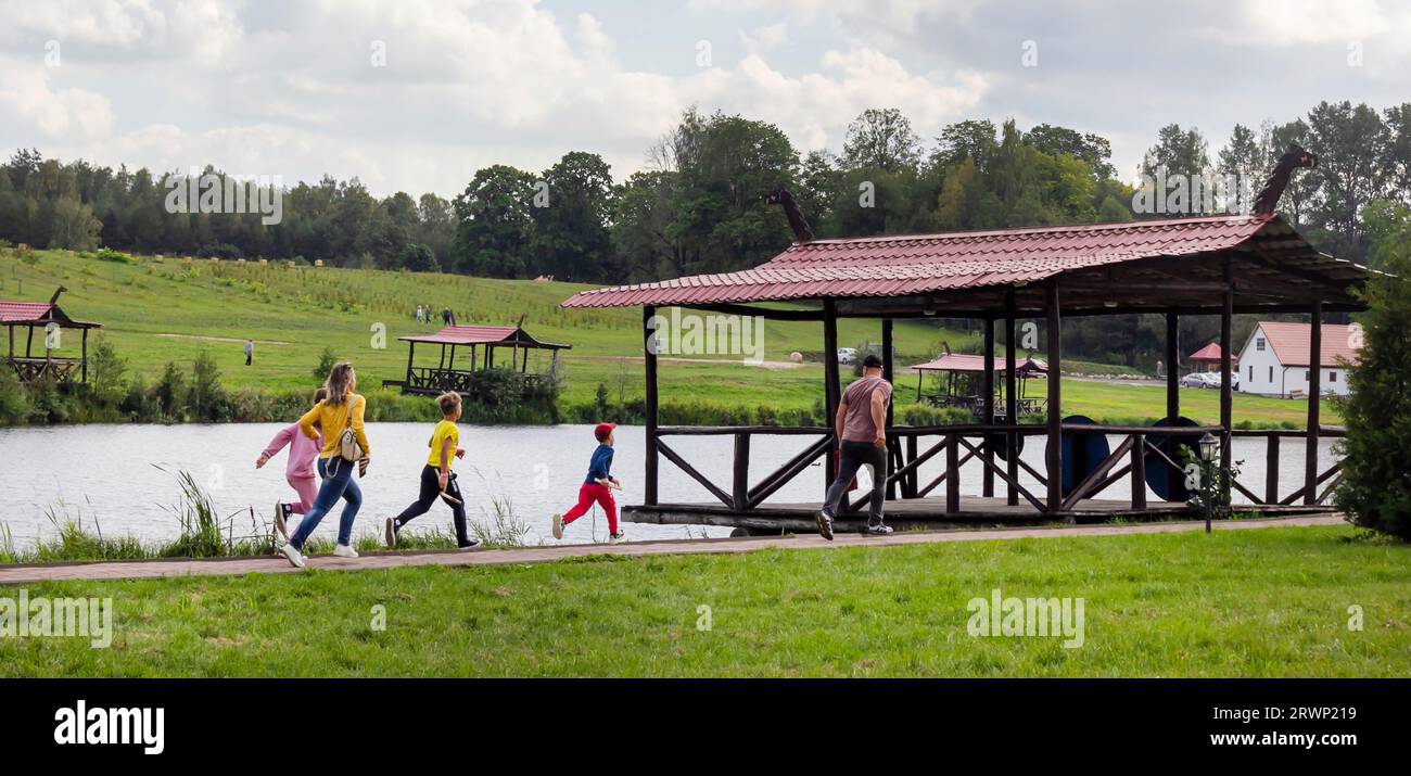 September 17, 2023, Belarus, Sula. A family runs together through the Grand Duchy of Sula interactive history park. Stock Photo