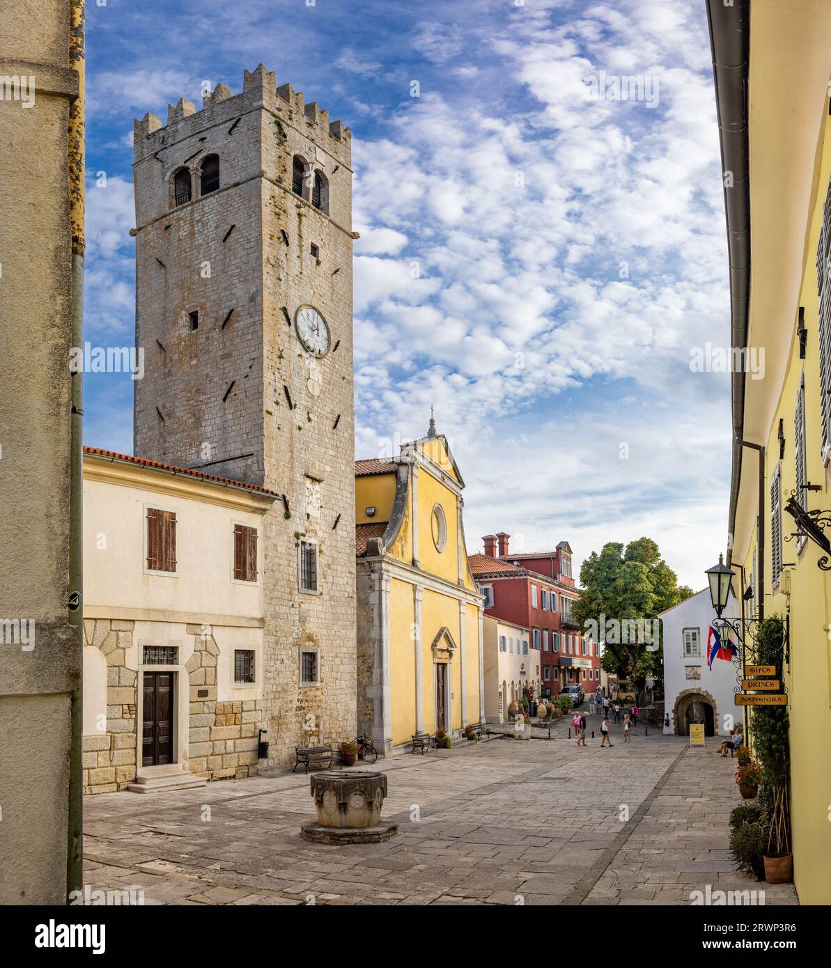 Motovun, CROATIA - September 13, 2023: Tourists on the main suare of the medieval mountain village Motovun. Belltower and church of Stephan in the mid Stock Photo