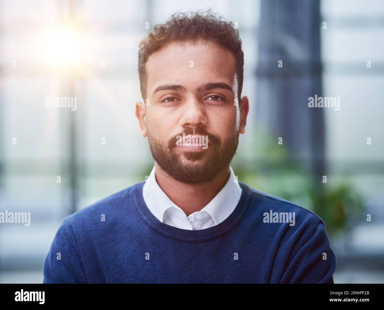 Smiling millennial confident black guy posing for photo, looking at camera Stock Photo