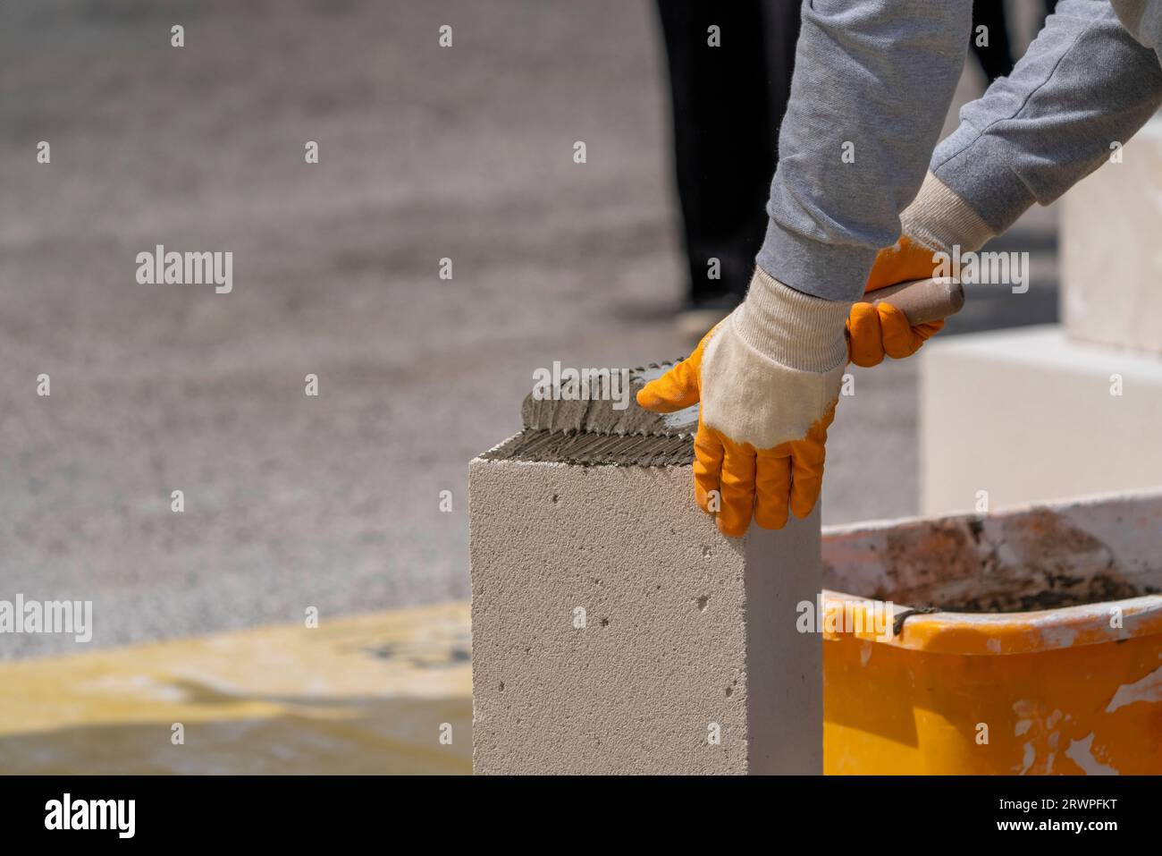 The bricklayer is working. Building a wall of aerated concrete. Stock Photo