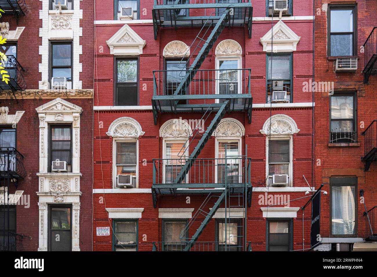 USA, New York City, Facade of late 19th early 20th Century townhouses in Nolita/Little Italy neighborhood of Lower Manhattan; fire escapes & windows Stock Photo