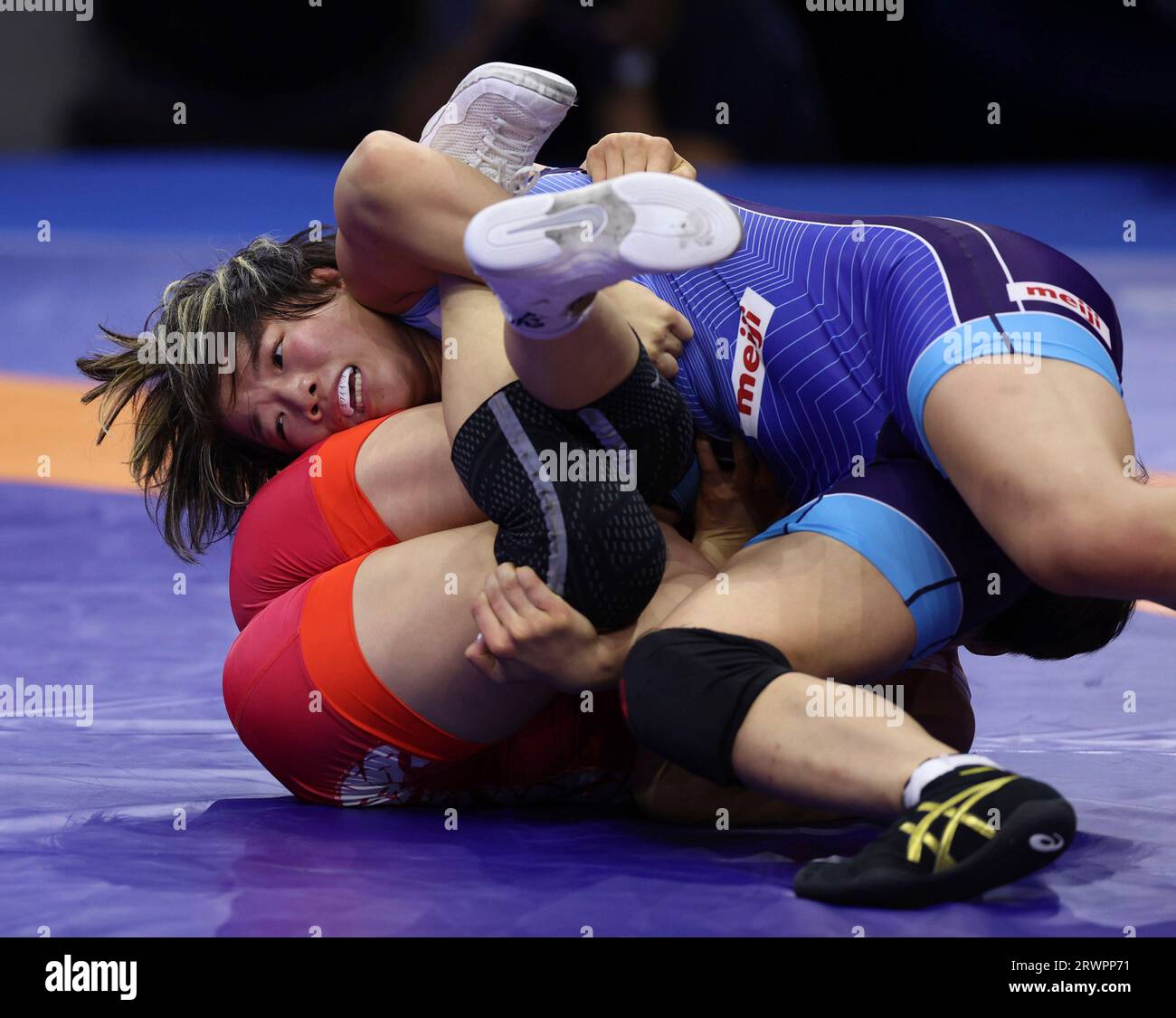 Yuka Kagami of Japan (blue) and Aiperi Medet Kyzy of Kyrgyzstan compete Yuka Kagami of Japan (blue) and Aiperi Medet Kyzy of Kyrgyzstan compete