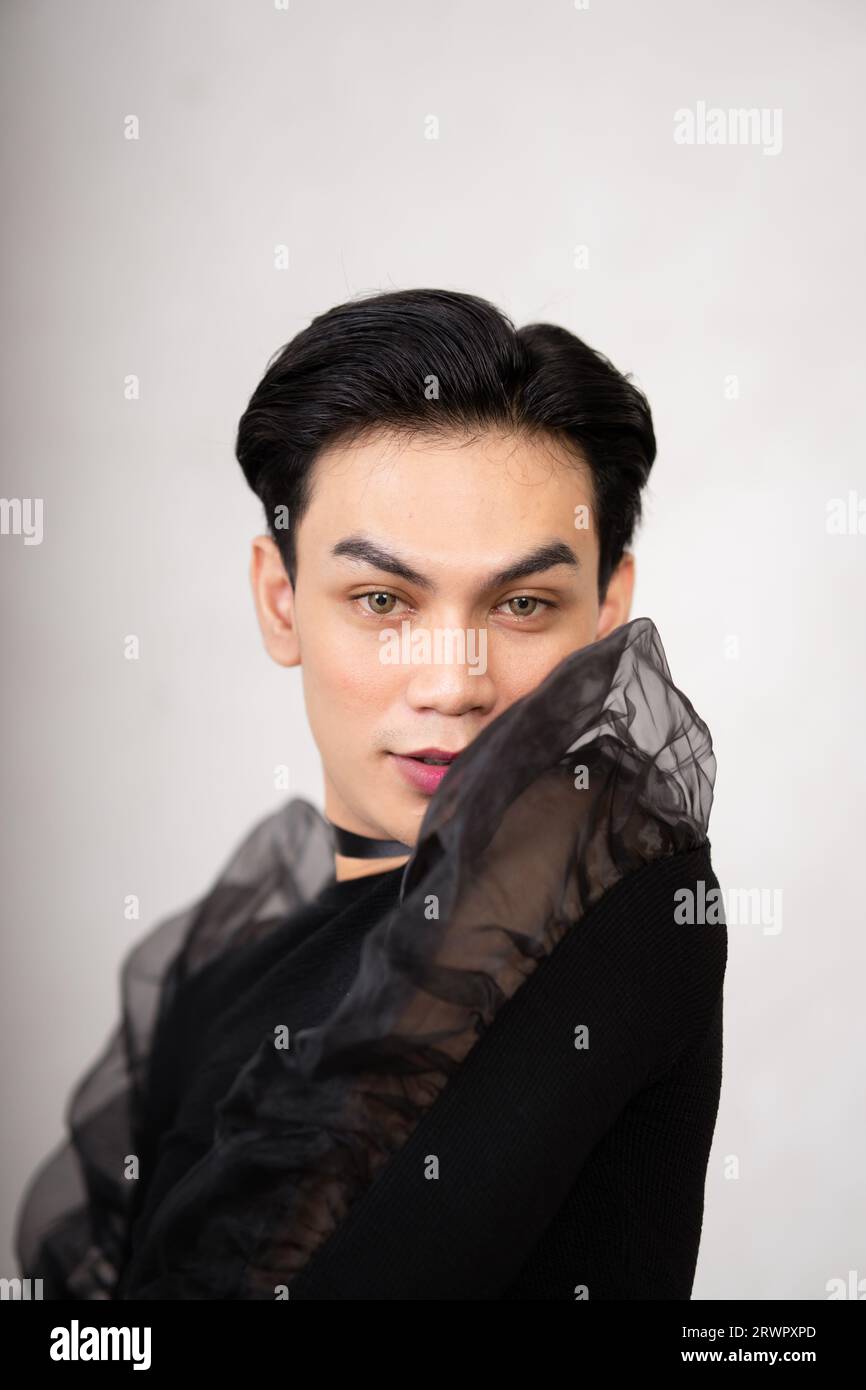Beautiful Asian man wearing a black dance costume before the performance begins at the backstage Stock Photo