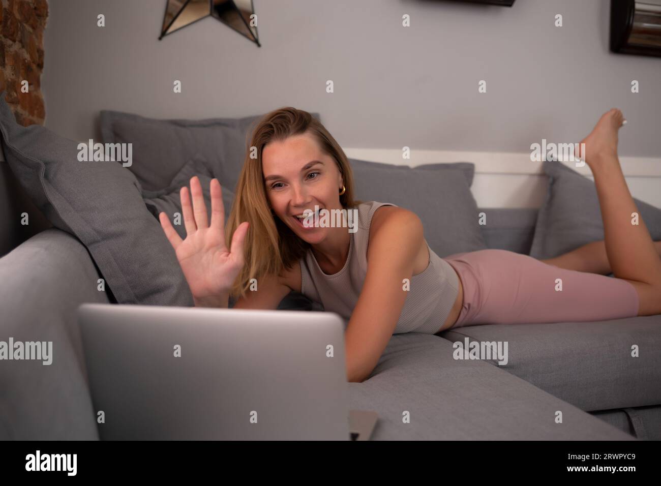 young beautiful woman working on a laptop in the living room in the ...