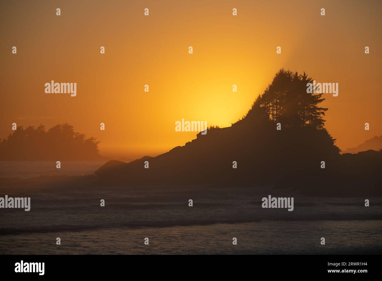 Cox Bay Beach at sunset with people silhouettes on Sunset Point, Tofino, Vancouver Island, British Columbia, Canada. Stock Photo