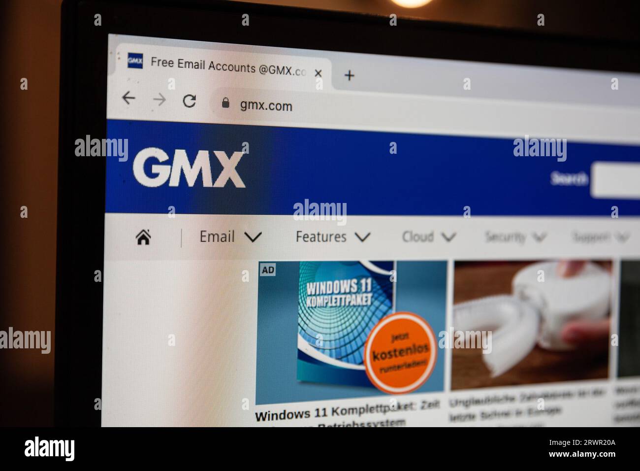 Picture of a sign with the logo of GMX on a screen of a desktop computer. GMX Mail is a free advertising-supported email service provided by GMX. User Stock Photo