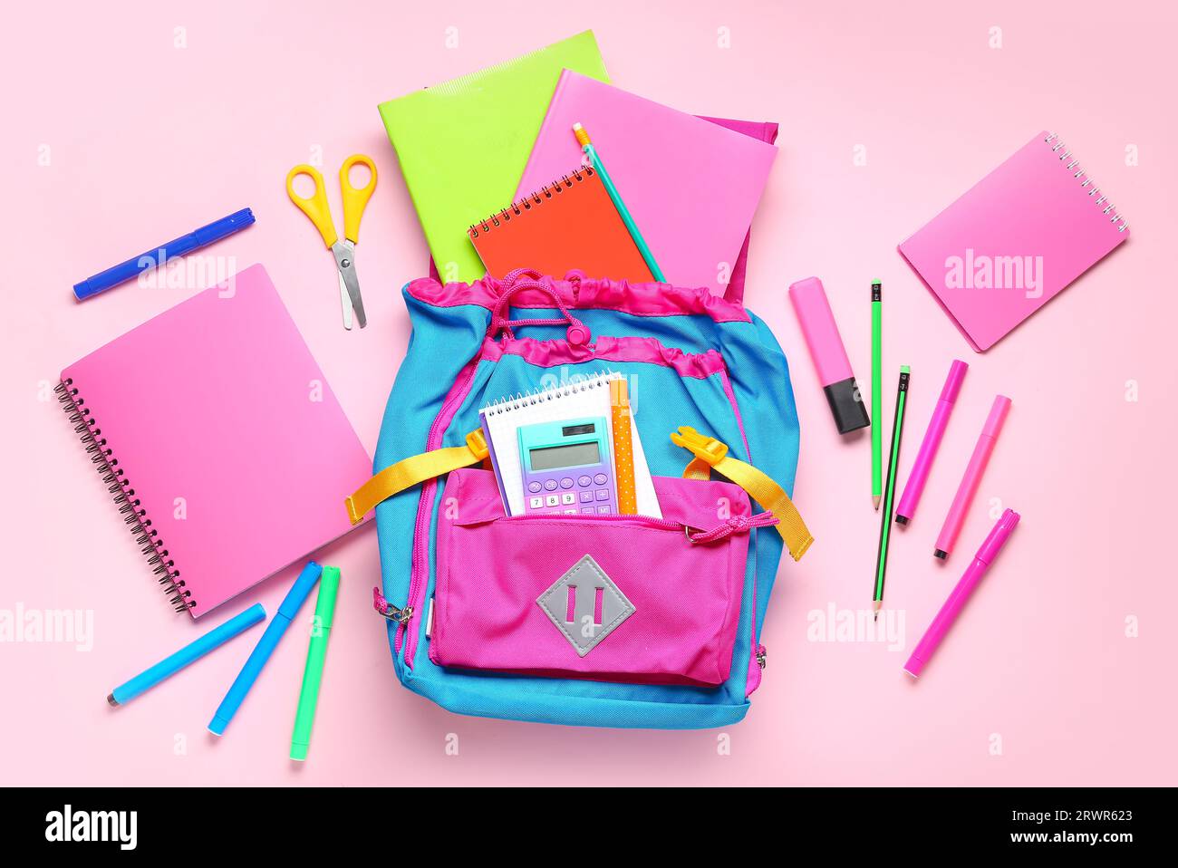 Stylish school backpack with different stationery on pink background Stock Photo