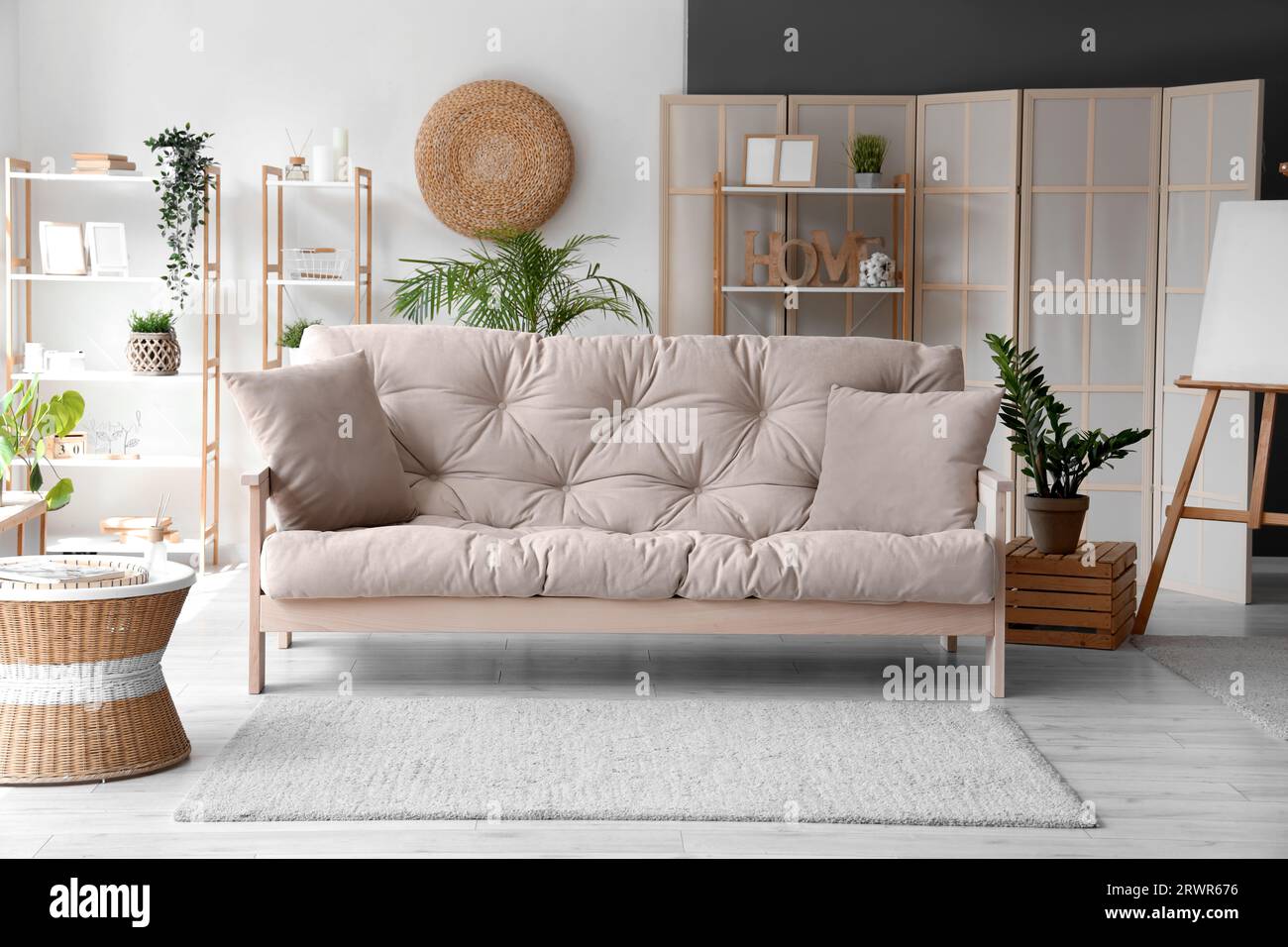 Interior of stylish living room with grey sofa Stock Photo - Alamy