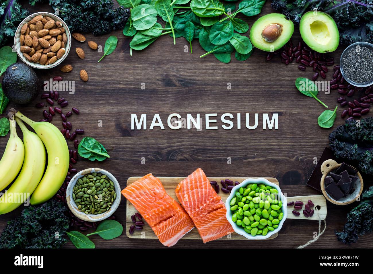 Healthy foods forming a border with the word Magnesium in the middle. Stock Photo