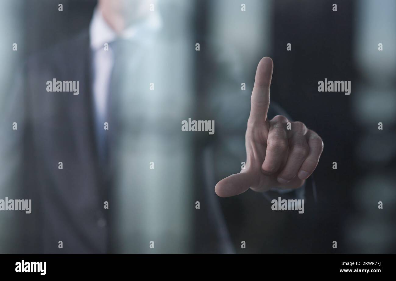 Business man pressing an imaginary button at his office. Stock Photo