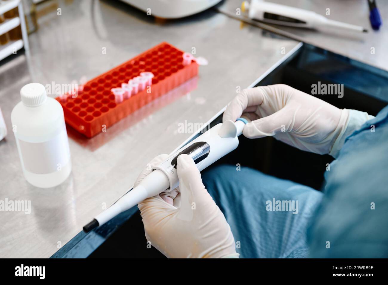 Technician works investigating analysis sample in test tubes Stock Photo