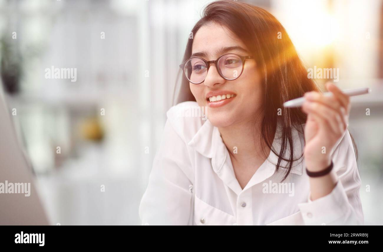 Beautiful young woman working with laptop in her office Stock Photo - Alamy