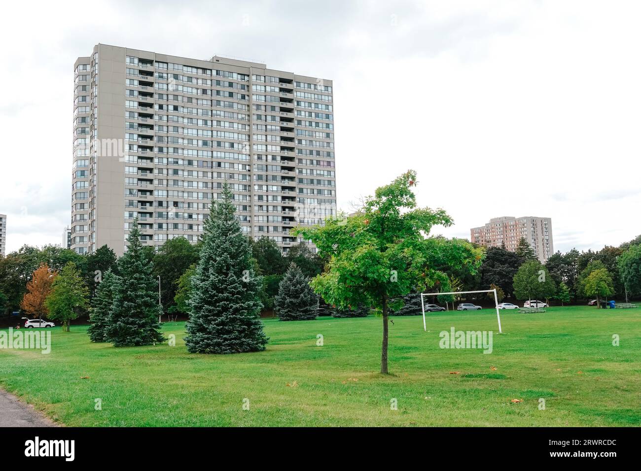 an apartment building built in the 1980s with a large park in front in Toronto Stock Photo