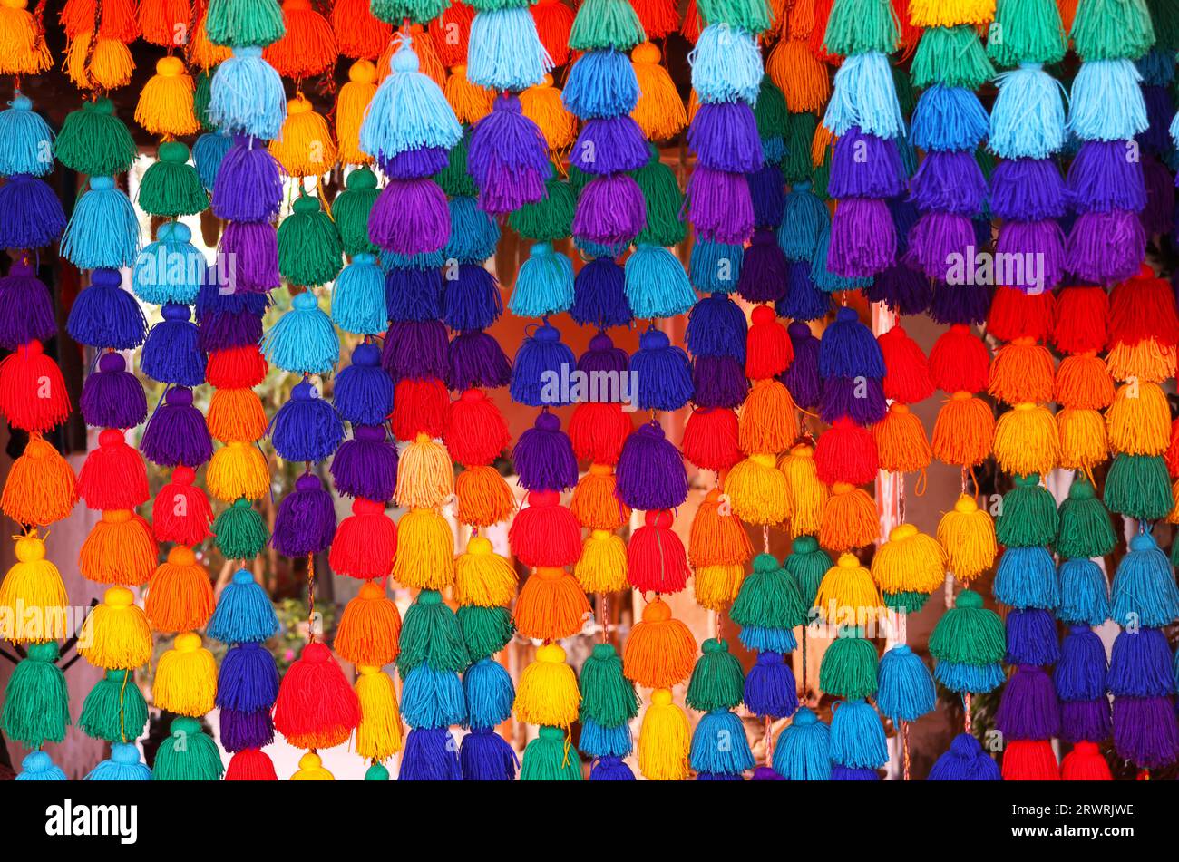 Multicolor woolen yarn hanging as a curtain in a store in Cusco, Peru Stock Photo