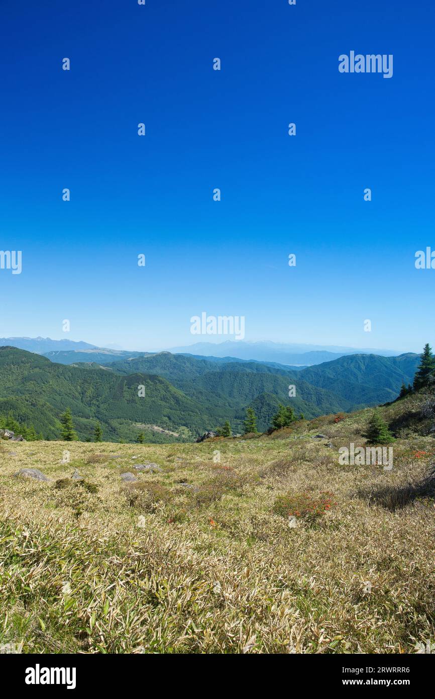 View of the Yatsugatake mountain range and the Southern Alps from Ohgahana Stock Photo