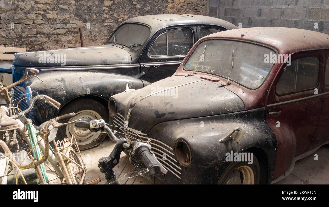 Bordeaux , France - 09 18 2023 : Renault 4CV and peugeot 203 fifties french oldtimer car old vintage retro vehicle in a dusty barn garage Stock Photo