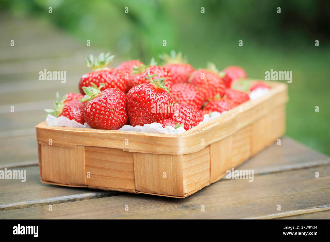 Fresh strawberries in a small wooden basket Stock Photo - Alamy