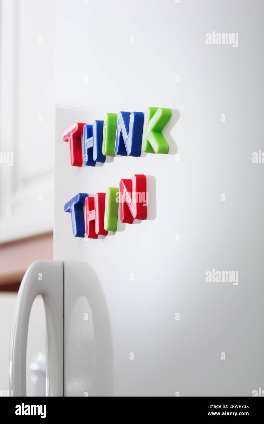 Words THINK THIN magnets on a refrigerator door Stock Photo
