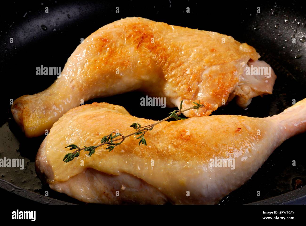 Sear the chicken thighs Stock Photo