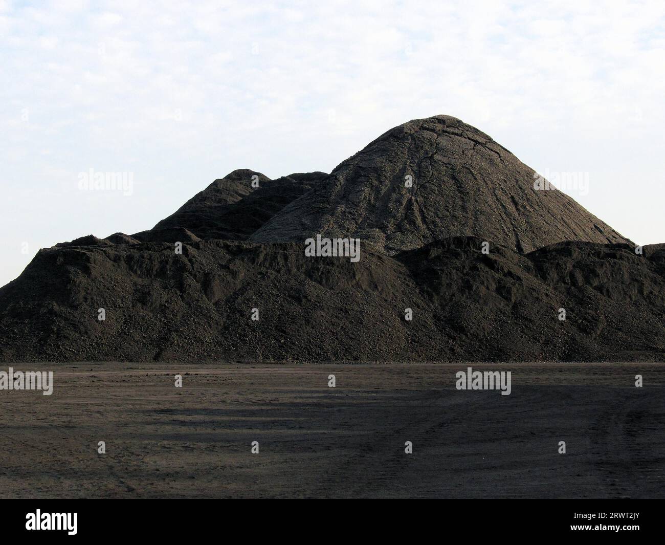 On the slag heap, coal mountain with paths made of coal and coal slag ...