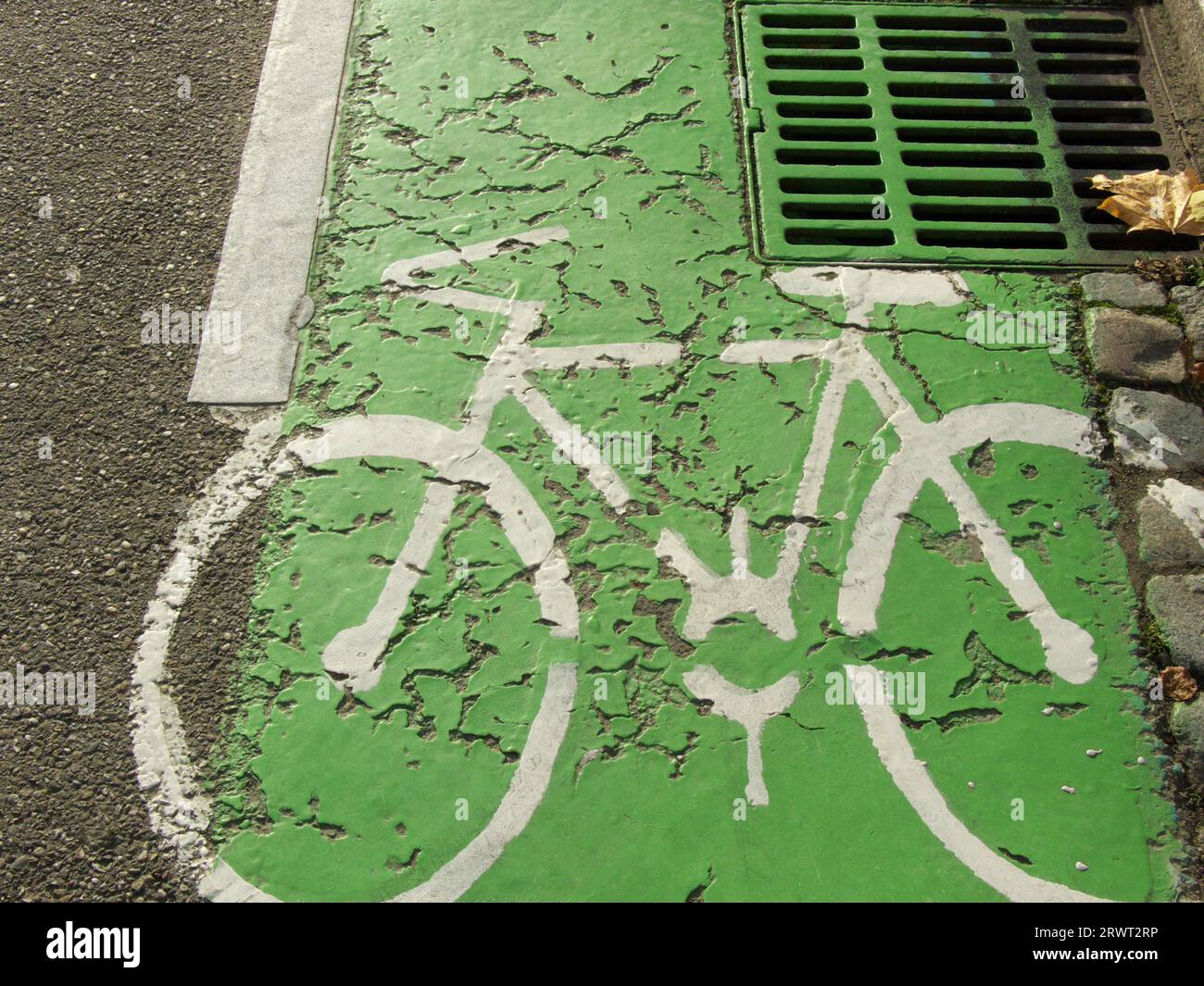 Bicycle lane marked with a white bicycle symbol in green Stock Photo ...