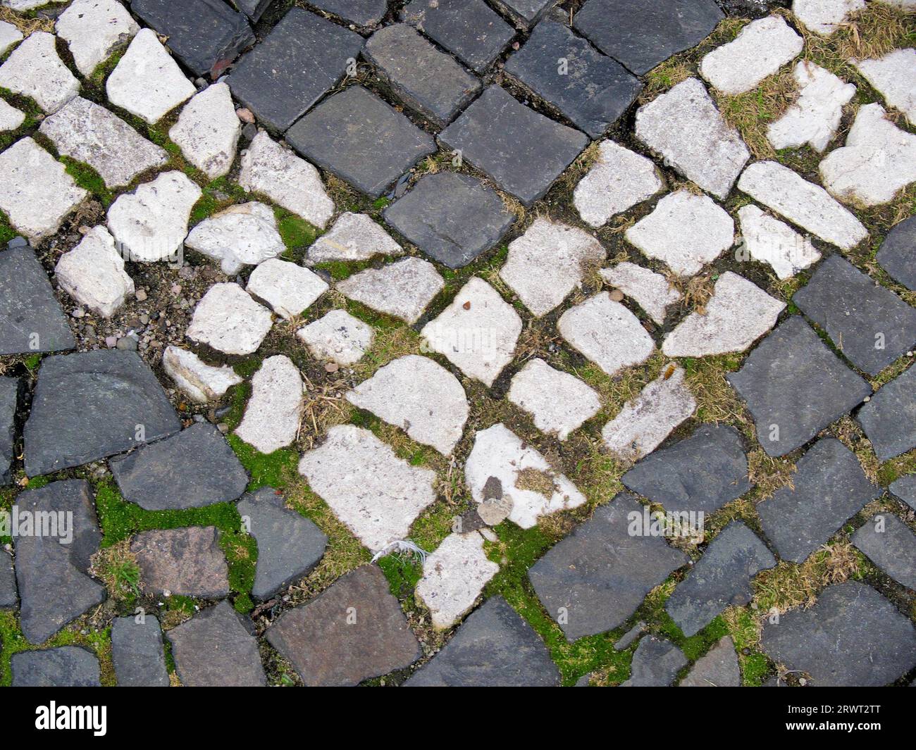 Paving pattern with grey and white painted paving stones, arrow symbol Stock Photo