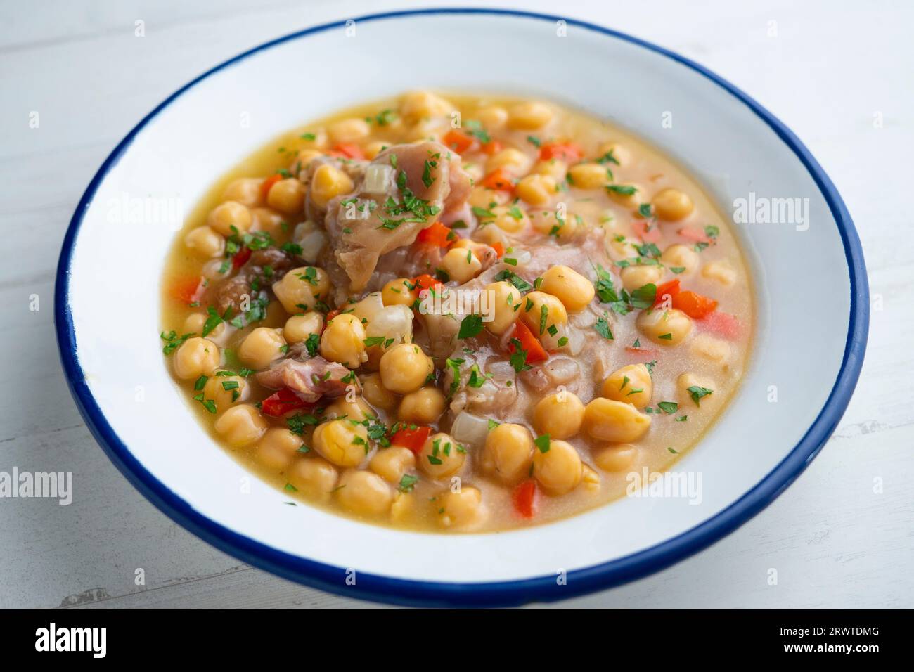 Stewed chickpeas with pig's feet. Traditional recipe from northern Spain. Stock Photo