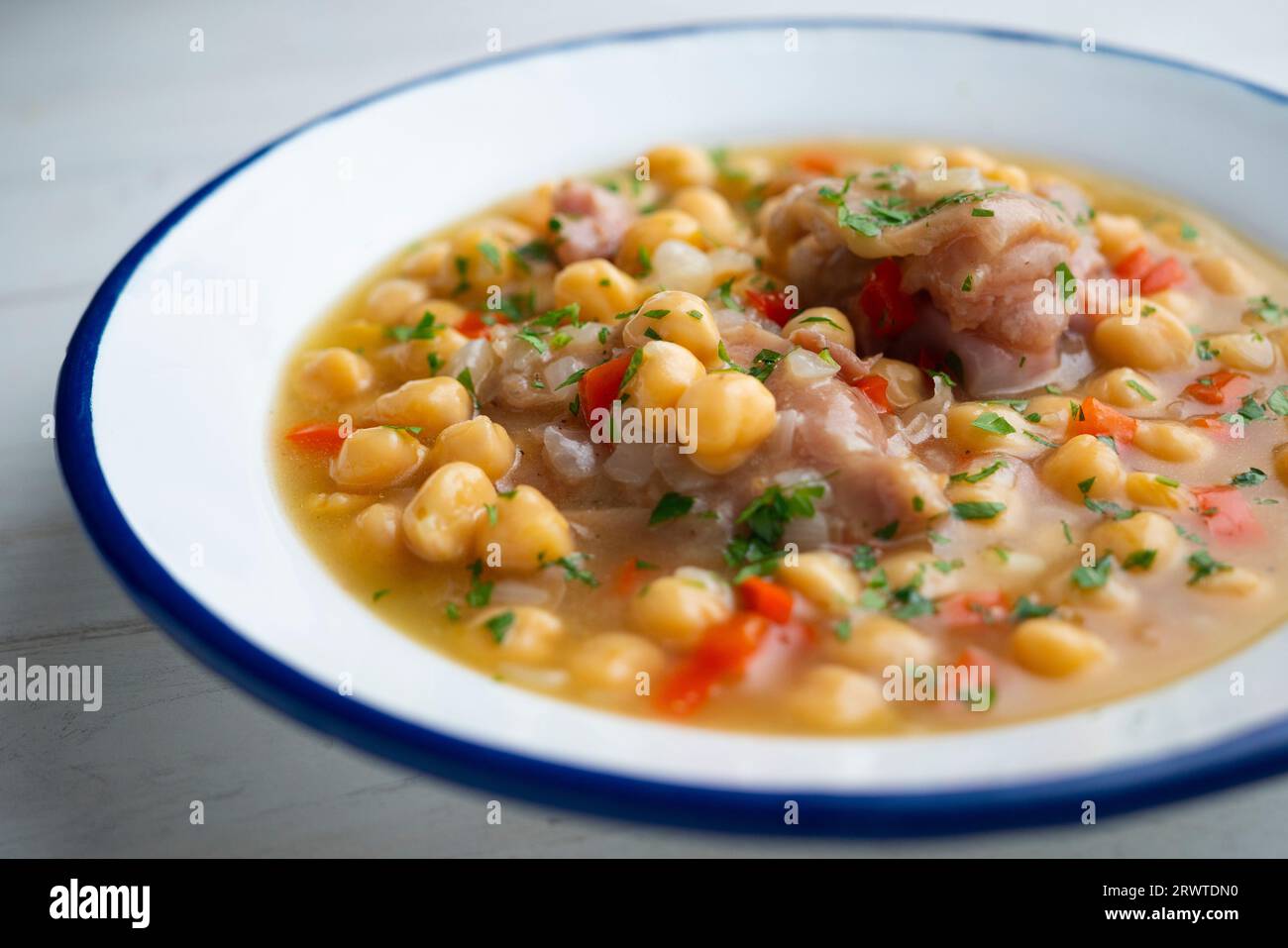 Stewed chickpeas with pig's feet. Traditional recipe from northern Spain. Stock Photo