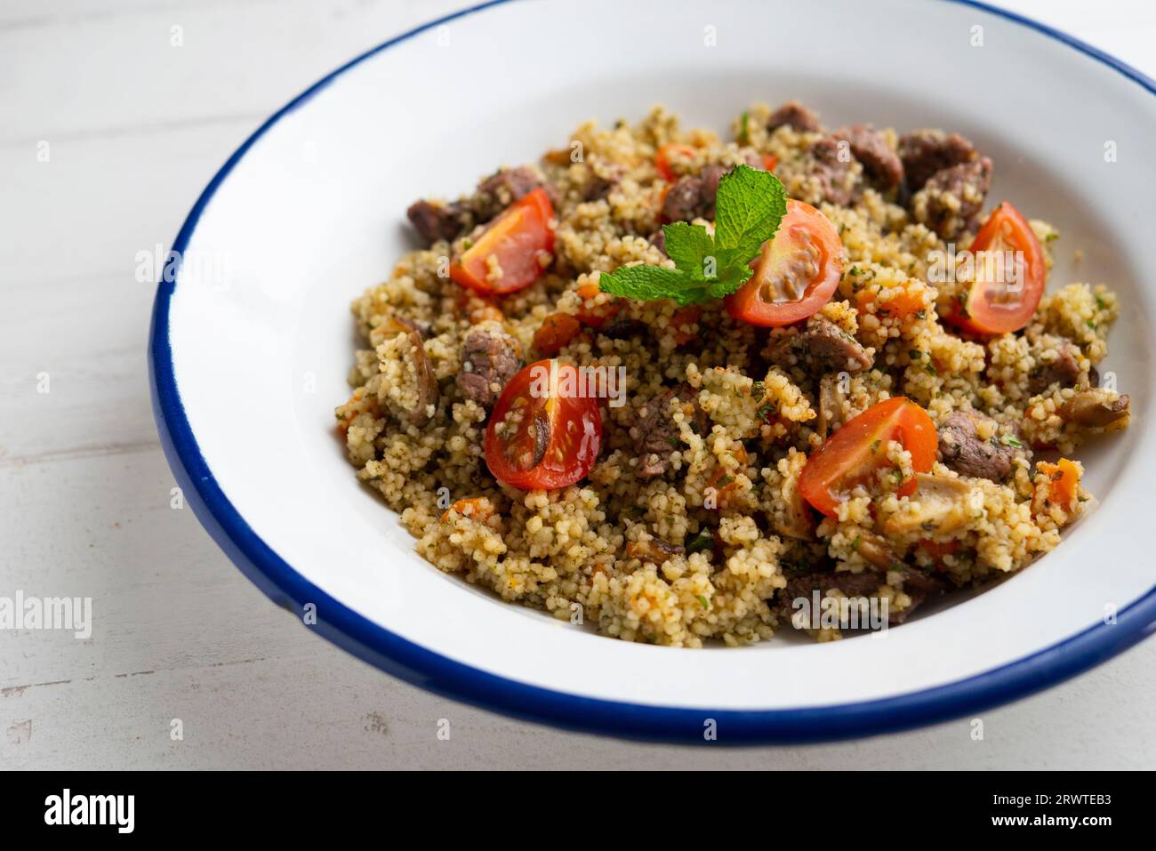 Couscous with vegetables and beef marinated with fresh mint Stock Photo