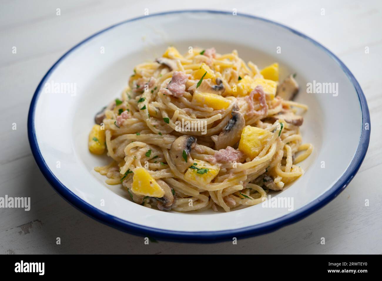 Spaghetti with carbonara sauce, ham and pineapple Stock Photo - Alamy