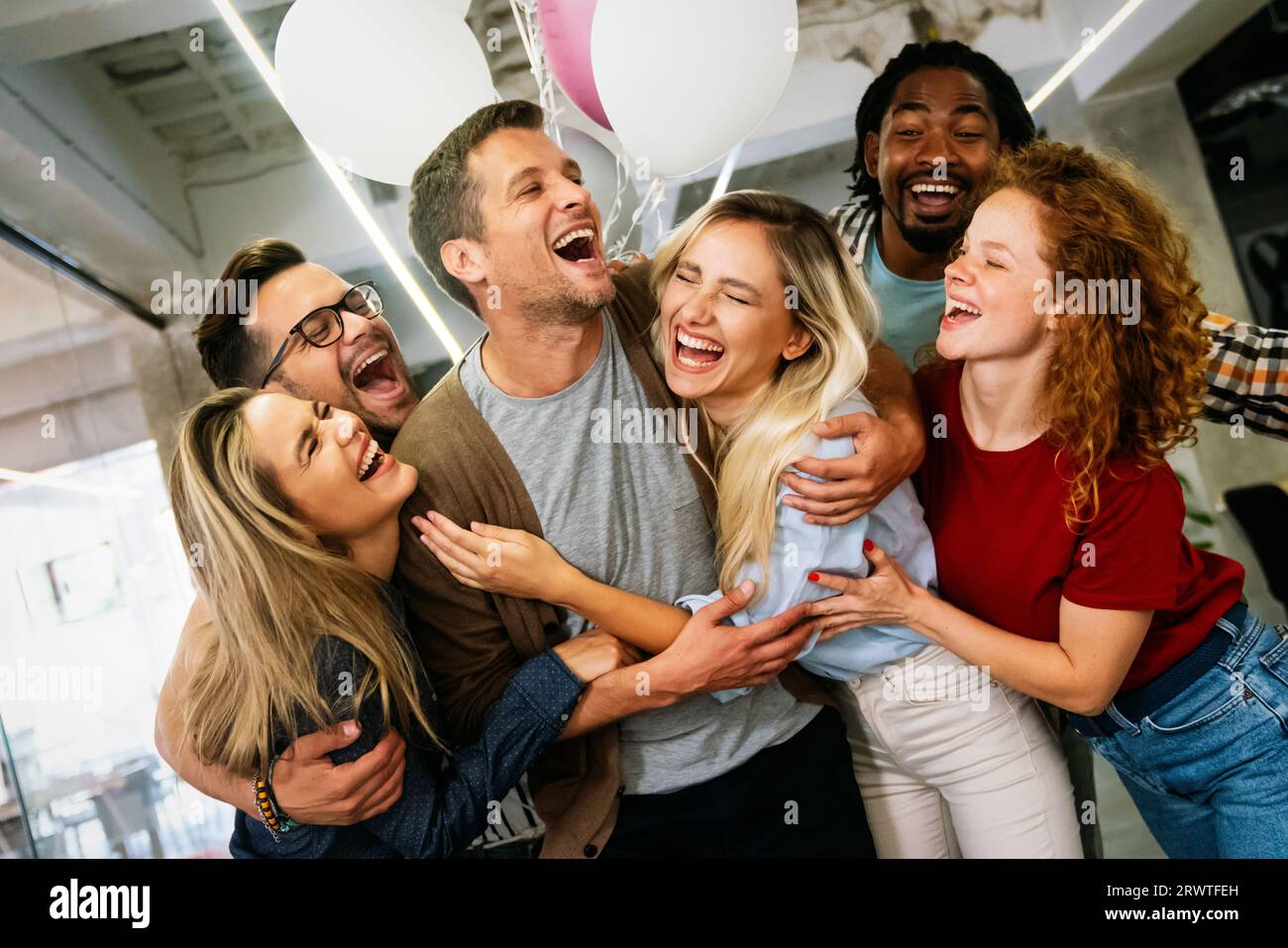 Group portrait of young startup business team celebrating success in the office Stock Photo