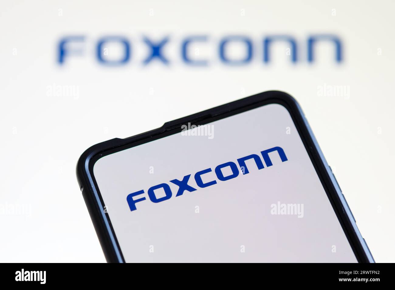 Stuttgart, Germany - July 20, 2023: Foxconn logo of the computer producer on a mobile phone and screen in Stuttgart, Germany. Stock Photo