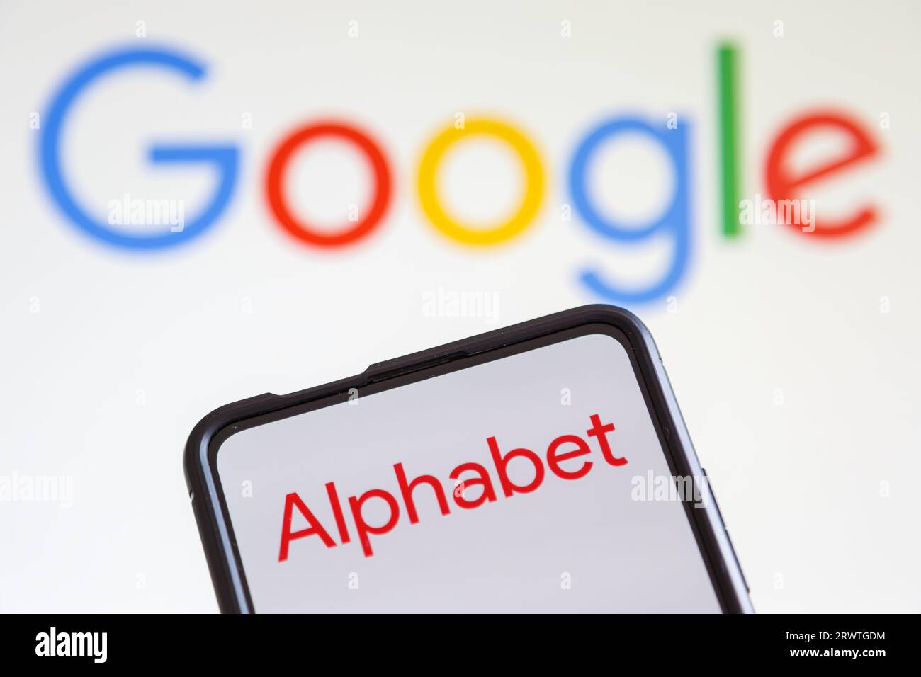 Stuttgart, Germany - July 20, 2023: Google and Alphabet logo of the computer hardware software manufacturer on a mobile phone and screen in Stuttgart, Stock Photo