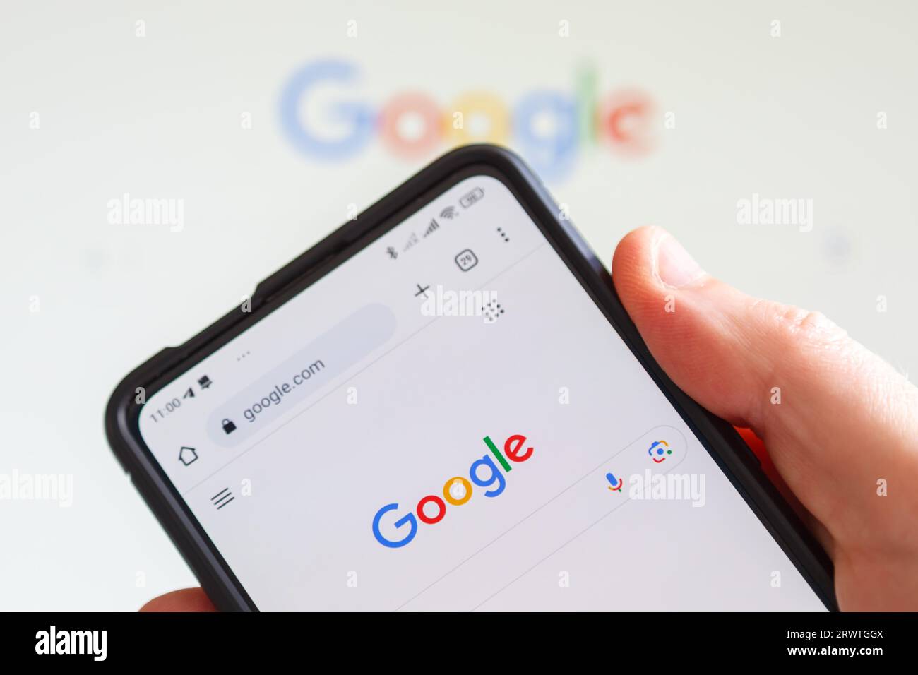 Stuttgart, Germany - July 23, 2023: Hand holding a mobile phone with Google logo of the computer hardware software manufacturer screen in Stuttgart, G Stock Photo