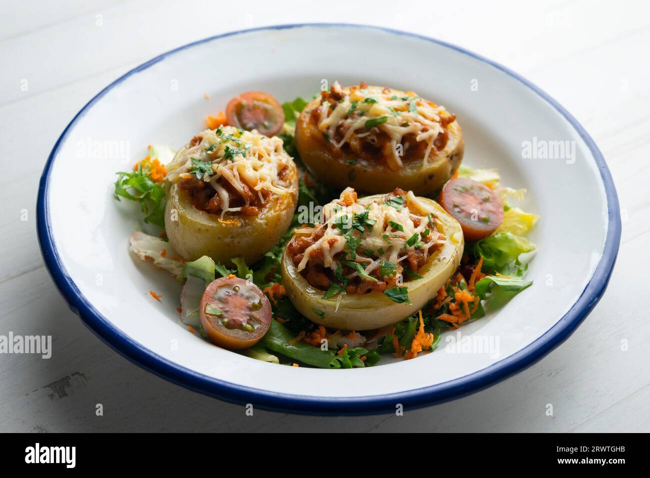 Potatoes stuffed with minced meat and tomato and baked in the oven with