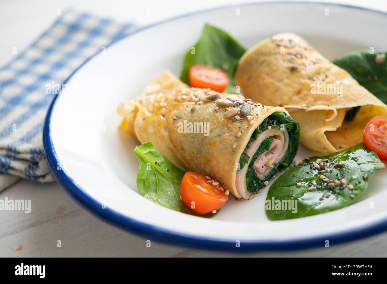 Crepe stuffed with ham and spinach. Stock Photo