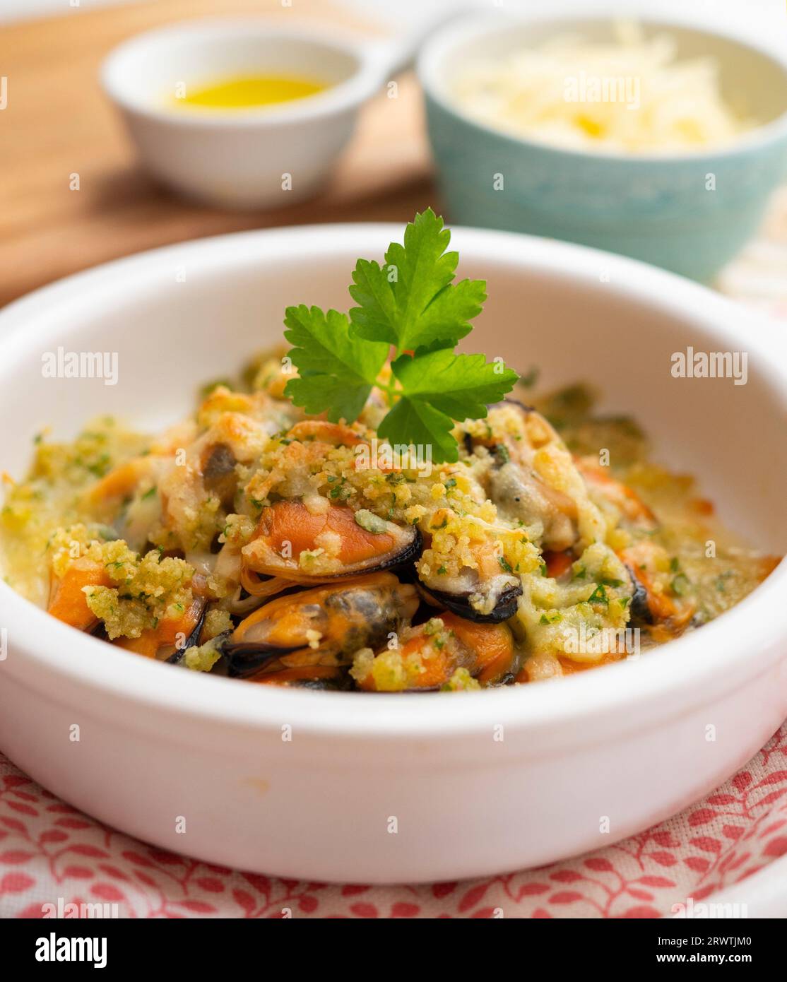 Mussels gratin. Gratin seafood dish with bread and parsley. Stock Photo