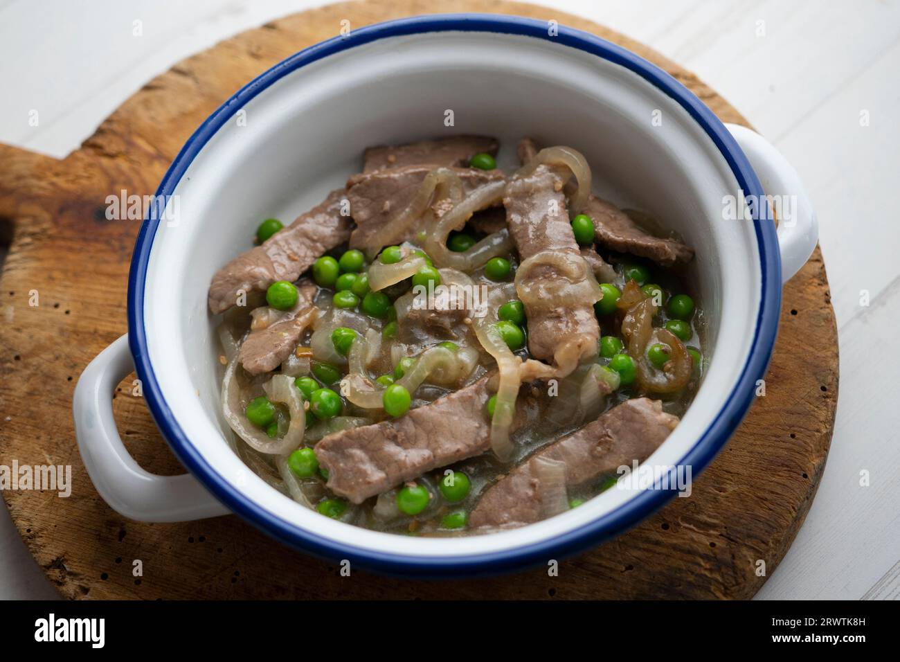 Beef strips cooked with onion and peas Stock Photo Alamy