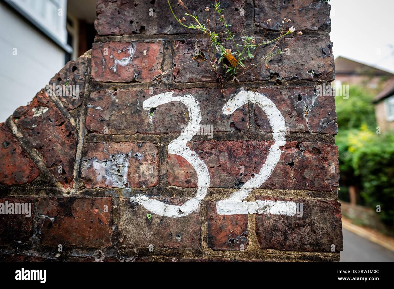 The Number 32 written on a old brick wall Stock Photo