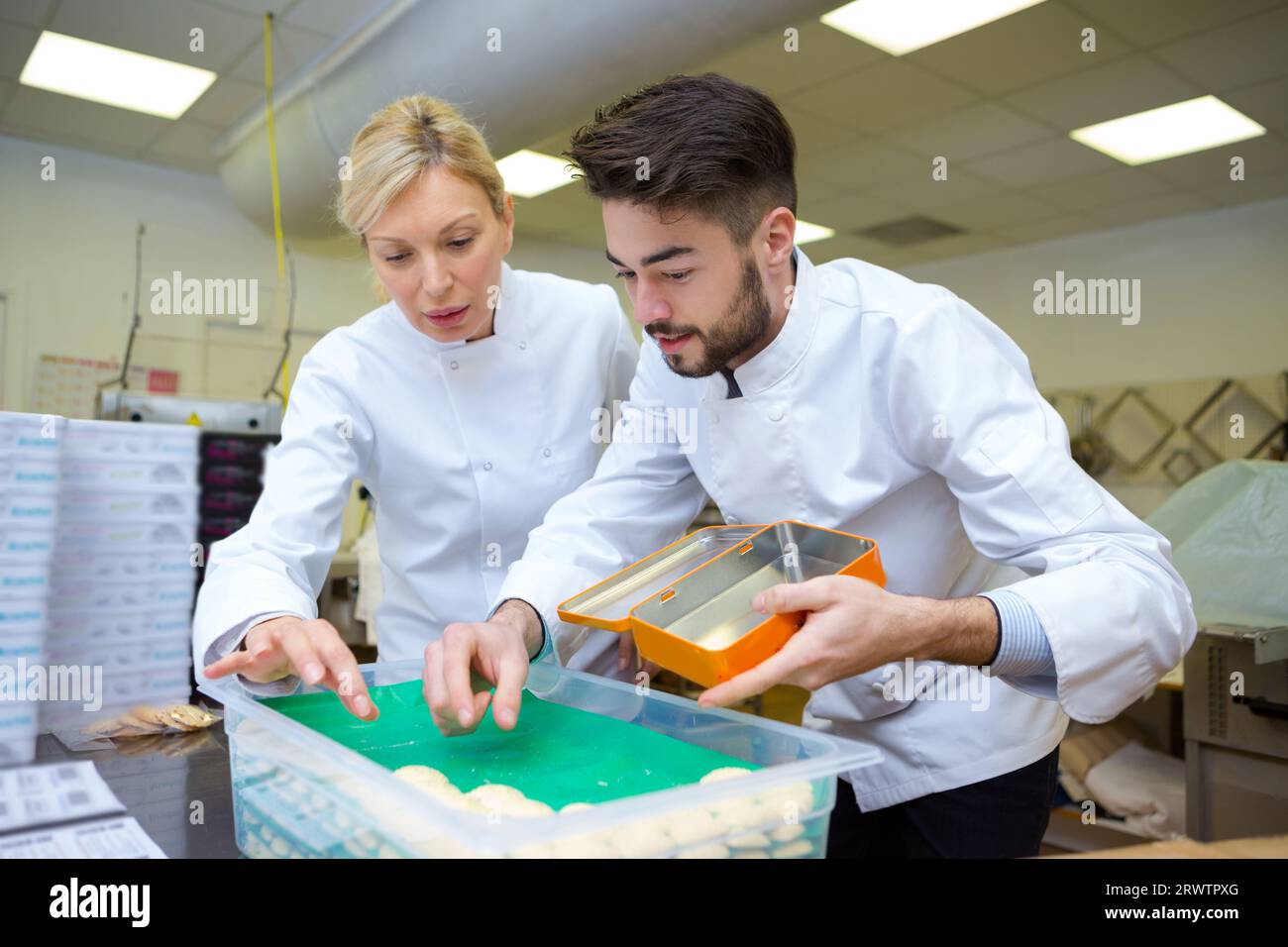 chefs choosing ingredients in professional kitchen Stock Photo