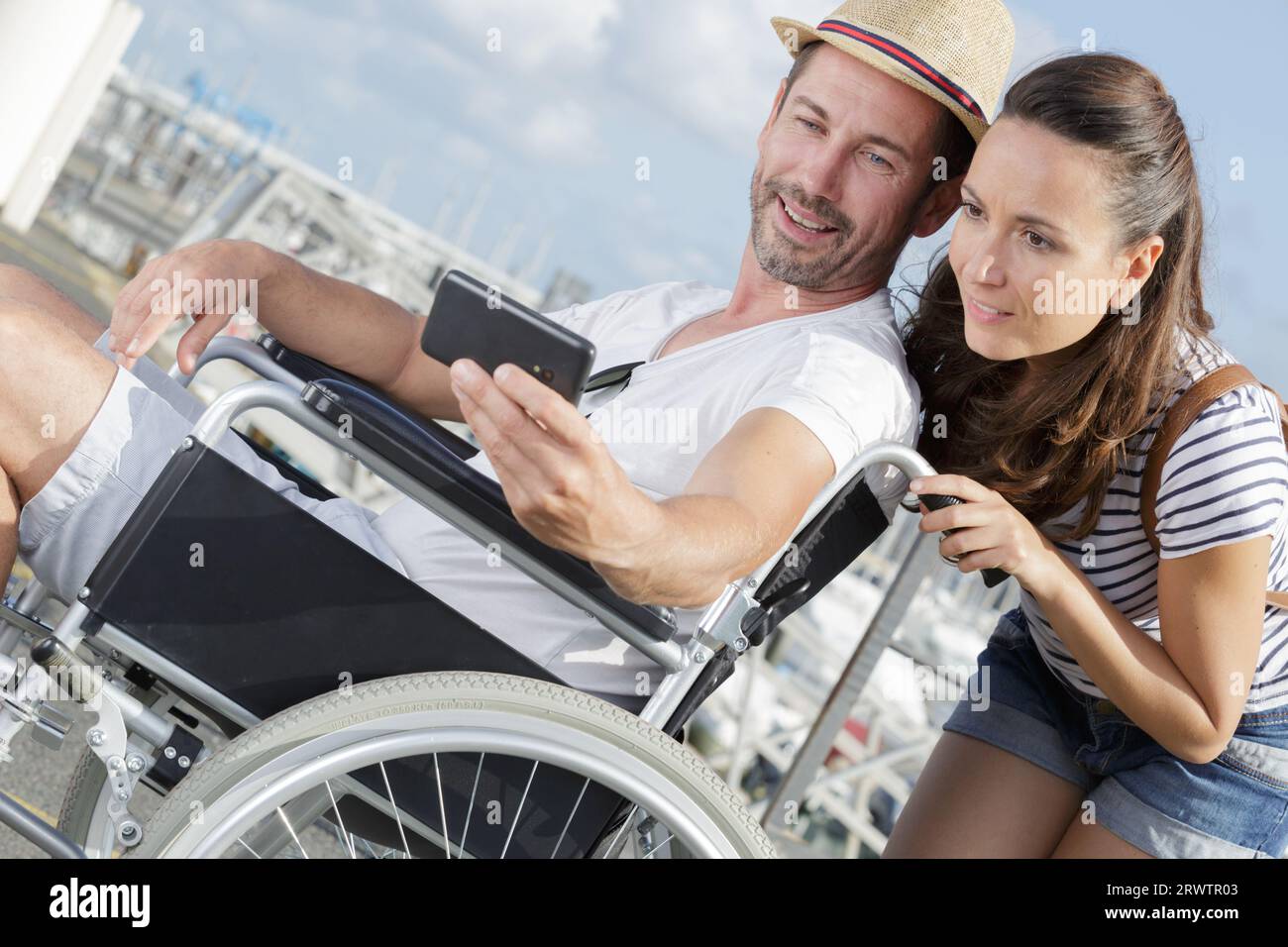 handicapped man in wheelchair and girlfriend taking a selfie Stock ...