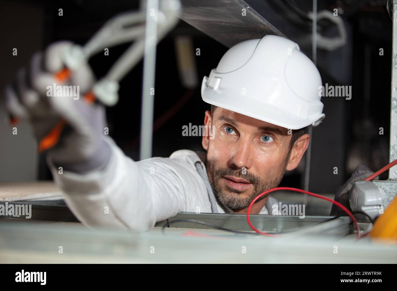 male electrician installing a ceiling equipment Stock Photo - Alamy