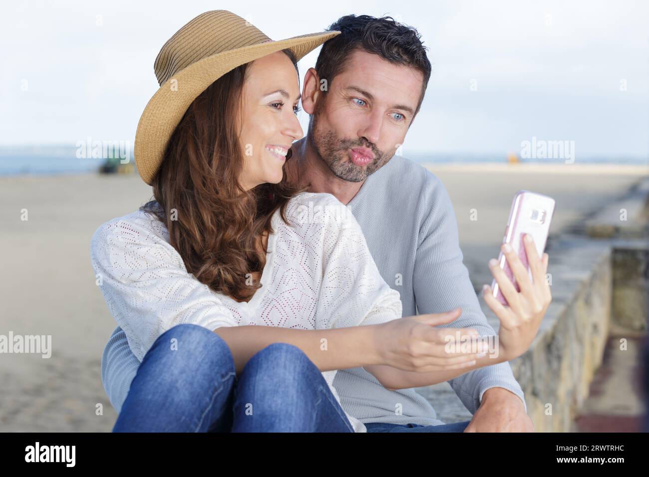 couple in love taking a selfie at the beach Stock Photo - Alamy