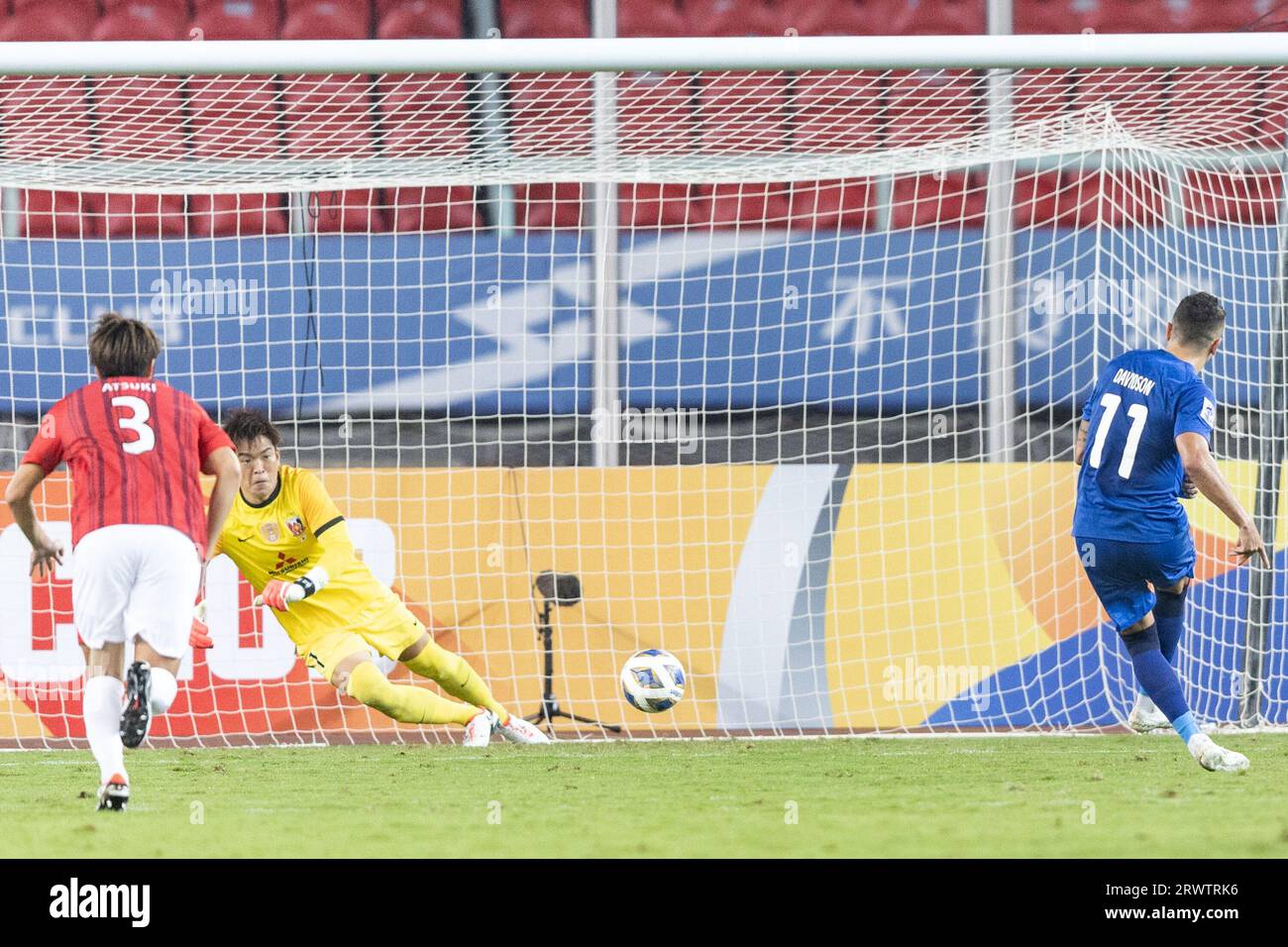 Wuhan, China. 20th Sep, 2023. Davidson Pereira (R) #11 of Wuhan Three Towns beats Shusaku Nishikawa #1 of the Urawa Red Diamonds for goal on a penalty kick during the AFC champions league group J match between China's Wuhan Three Towns and Japan's Urawa Red Diamonds at the 2023 AFC Champions League. Wuhan Three Towns, who were crowned in Chinese Super League in their maiden journey in 2022, drew with the three-time titleholder Urawa Red Diamonds 2-2 at home in the Chinese team's AFC Champions League debut. (Photo by RenYong/SOPA Images/Sipa USA) Credit: Sipa USA/Alamy Live News Stock Photo