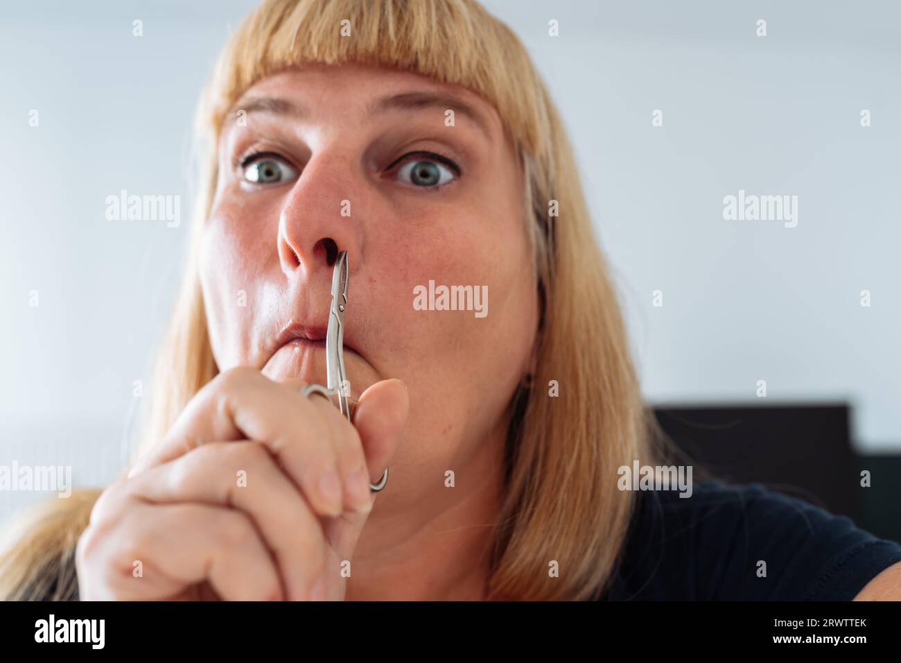 portrait woman plucking facial hair with tweezers Stock Photo Alamy