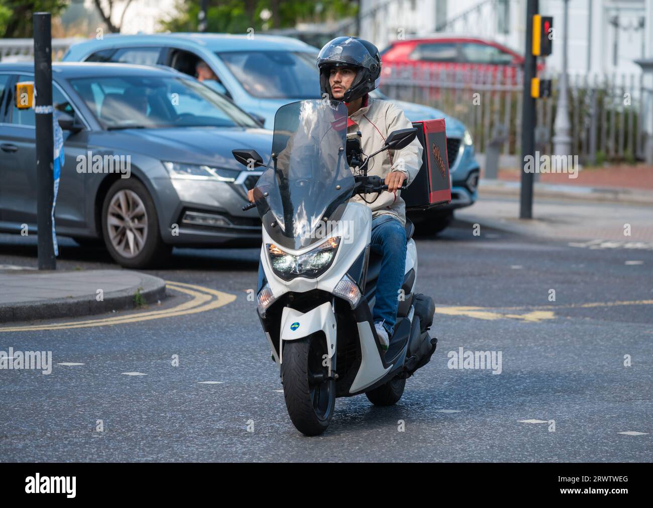 Delivery Rider Nmax Front view of delivery driver riding on a Yamaha NMAX 125 motor scooter ...
