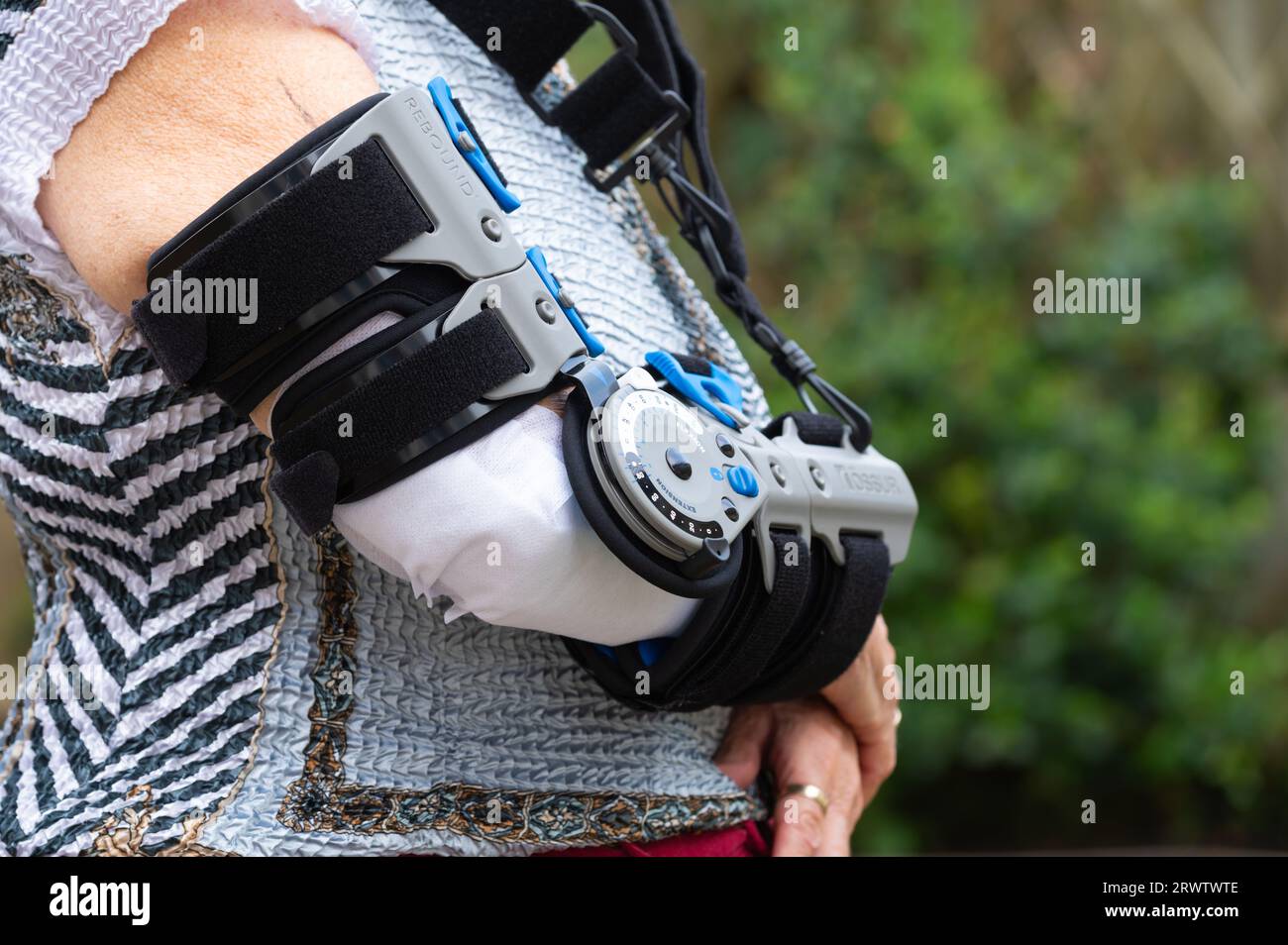 Elderly woman wearing an Ossur Rebound PostOp Elbow Brace, after